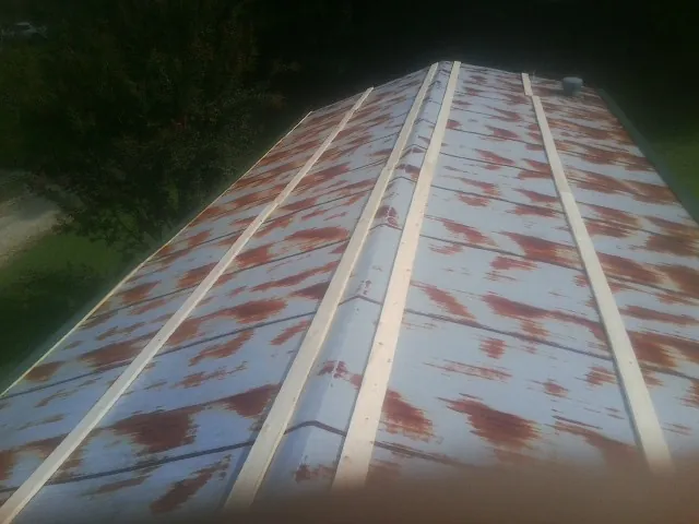 Rusted metal roof panels with new wood purlins before replacement — Storm Damage Roof Repair in Prichard by Roofing Brothers